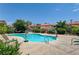 Community pool with trees, landscaping, and two basketball hoops at 6735 W Charleston Blvd # 4, Las Vegas, NV 89146