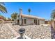 The house exterior features backyard with a concrete pad and river rock landscaping at 6961 Ray Charles Ln, Las Vegas, NV 89119