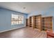 Bedroom featuring wood-look flooring and built-in bookshelves at 6961 Ray Charles Ln, Las Vegas, NV 89119