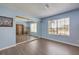 Bright bedroom features a large window, wood floors and a mirrored closet, creating a sense of spaciousness at 6961 Ray Charles Ln, Las Vegas, NV 89119