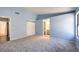 Bedroom featuring neutral carpet, ensuite bathroom, and a sliding-door closet at 6961 Ray Charles Ln, Las Vegas, NV 89119