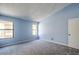 Bright bedroom featuring two windows, neutral carpeting and ample wall space at 6961 Ray Charles Ln, Las Vegas, NV 89119