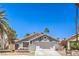 Charming single-story home with a well-maintained front yard and a two-car garage at 6961 Ray Charles Ln, Las Vegas, NV 89119