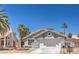 Charming single-story home with a well-maintained front yard and a two-car garage at 6961 Ray Charles Ln, Las Vegas, NV 89119