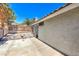 Exterior of the house featuring a covered patio and drought-resistant landscaping at 6961 Ray Charles Ln, Las Vegas, NV 89119