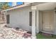 Home's front entry featuring a textured wall and a rock and brick planter at 6961 Ray Charles Ln, Las Vegas, NV 89119