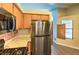 Efficient kitchen featuring stainless steel appliances, wood cabinetry, and eat in bar access at 6961 Ray Charles Ln, Las Vegas, NV 89119