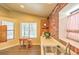 Bright eating area with a breakfast table, natural light, and charming brick accents at 6961 Ray Charles Ln, Las Vegas, NV 89119