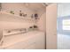 Functional laundry area with washer, dryer, and shelving for storage at 6961 Ray Charles Ln, Las Vegas, NV 89119