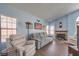 Inviting living room with neutral toned furniture, fireplace, and wood floors at 6961 Ray Charles Ln, Las Vegas, NV 89119