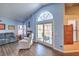 Bright living room with neutral toned furniture, fireplace, and sliding doors at 6961 Ray Charles Ln, Las Vegas, NV 89119