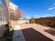 The backyard includes desert landscaping and plants and a brick fence at 8125 Rio De Janeiro Dr, Las Vegas, NV 89128