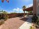 A view of the backyard with a covered patio and desert landscaping at 8125 Rio De Janeiro Dr, Las Vegas, NV 89128