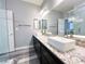 Bright bathroom featuring dual sinks, granite countertops, and a glass-enclosed shower at 8125 Rio De Janeiro Dr, Las Vegas, NV 89128
