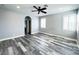 Spacious bedroom featuring a ceiling fan, hardwood floors, and arched doorway at 8125 Rio De Janeiro Dr, Las Vegas, NV 89128