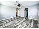 Bright bedroom featuring a ceiling fan, gray hardwood floors, and natural light at 8125 Rio De Janeiro Dr, Las Vegas, NV 89128