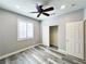 Bedroom featuring gray walls, wood-look flooring, a ceiling fan, closet, and a door at 8125 Rio De Janeiro Dr, Las Vegas, NV 89128