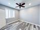 Bedroom with modern fan, white shuttered window, and wood look flooring at 8125 Rio De Janeiro Dr, Las Vegas, NV 89128