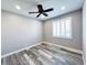 Bedroom featuring gray walls, a ceiling fan, a window with shutters, and gray wood-look flooring at 8125 Rio De Janeiro Dr, Las Vegas, NV 89128