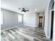 Open bedroom with grey hardwood floors and natural light at 8125 Rio De Janeiro Dr, Las Vegas, NV 89128