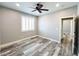Bedroom with gray walls, wood-look floors, ceiling fan, window, and white trim at 8125 Rio De Janeiro Dr, Las Vegas, NV 89128