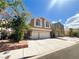 Beautiful two-story home with a spacious driveway, a two-car garage, and lush landscaping, a great Gathering residence at 8125 Rio De Janeiro Dr, Las Vegas, NV 89128