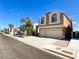 Attractive two-story home showcasing a spacious driveway, two-car garage, and well-maintained landscaping, inviting curb appeal at 8125 Rio De Janeiro Dr, Las Vegas, NV 89128