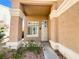 Charming home entrance with a covered porch, neat landscaping, and a single-car garage for convenient parking at 8125 Rio De Janeiro Dr, Las Vegas, NV 89128