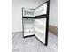 Garage interior featuring an open black refrigerator with white shelving at 8125 Rio De Janeiro Dr, Las Vegas, NV 89128