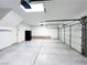 Well-lit two car garage with speckled epoxy flooring and automatic doors at 8125 Rio De Janeiro Dr, Las Vegas, NV 89128