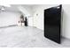 Epoxy floor two-car garage featuring water heater and black refrigerator at 8125 Rio De Janeiro Dr, Las Vegas, NV 89128