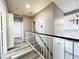 The upstairs hallway landing features wood-look floors and neutral paint at 8125 Rio De Janeiro Dr, Las Vegas, NV 89128