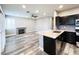 Modern kitchen features stainless steel appliances, granite countertops, and hardwood floors at 8125 Rio De Janeiro Dr, Las Vegas, NV 89128