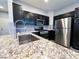 Kitchen features granite counters and stainless appliances at 8125 Rio De Janeiro Dr, Las Vegas, NV 89128