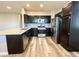 Contemporary kitchen with stainless appliances, granite counters, and dark cabinetry at 8125 Rio De Janeiro Dr, Las Vegas, NV 89128
