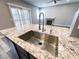 The kitchen island features a stainless steel sink and granite countertop at 8125 Rio De Janeiro Dr, Las Vegas, NV 89128
