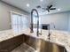 Features a kitchen island with a stainless steel sink and granite countertops at 8125 Rio De Janeiro Dr, Las Vegas, NV 89128