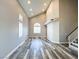 Bright living room features high ceilings, shuttered windows and wood-look floors at 8125 Rio De Janeiro Dr, Las Vegas, NV 89128