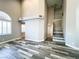 Open-plan living room leads to staircase and hallways, with wood-look flooring at 8125 Rio De Janeiro Dr, Las Vegas, NV 89128