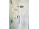 Modern shower featuring marble-style tile and a contemporary shower head fixture at 8125 Rio De Janeiro Dr, Las Vegas, NV 89128