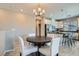 Dining area shows a round table, four chairs, and contemporary lighting fixture at 8490 Classique Ave # 101, Las Vegas, NV 89178