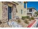Close-up of townhome entrance with stone facade, dark door, and landscaped front yard at 8490 Classique Ave # 101, Las Vegas, NV 89178