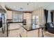 Bright kitchen features stainless appliances, granite counters, and a breakfast bar at 8490 Classique Ave # 101, Las Vegas, NV 89178