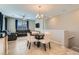 Open-concept living room features neutral tones, ceiling fan, and cozy seating area at 8490 Classique Ave # 101, Las Vegas, NV 89178
