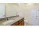 Bright bathroom featuring granite counters, a modern vanity, and a shower-tub combo at 89 Via Franello, Henderson, NV 89011