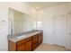 Spacious bathroom featuring double vanity, granite countertop, and large mirror at 89 Via Franello, Henderson, NV 89011