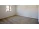 Spacious carpeted bedroom features a bright window and neutral decor at 89 Via Franello, Henderson, NV 89011