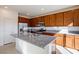 Modern kitchen with large island, stainless steel appliances and extensive brown wood cabinets at 89 Via Franello, Henderson, NV 89011