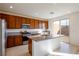 Modern kitchen featuring an island, granite countertops, stainless steel appliances, and stylish cabinetry at 89 Via Franello, Henderson, NV 89011