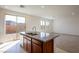 Modern kitchen with island, stainless steel appliances, granite countertop, with easy access to the living room at 89 Via Franello, Henderson, NV 89011